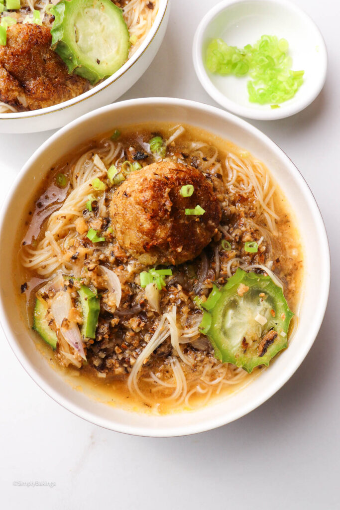 Bowl of plant-based meatballs, noodles, and tomato broth