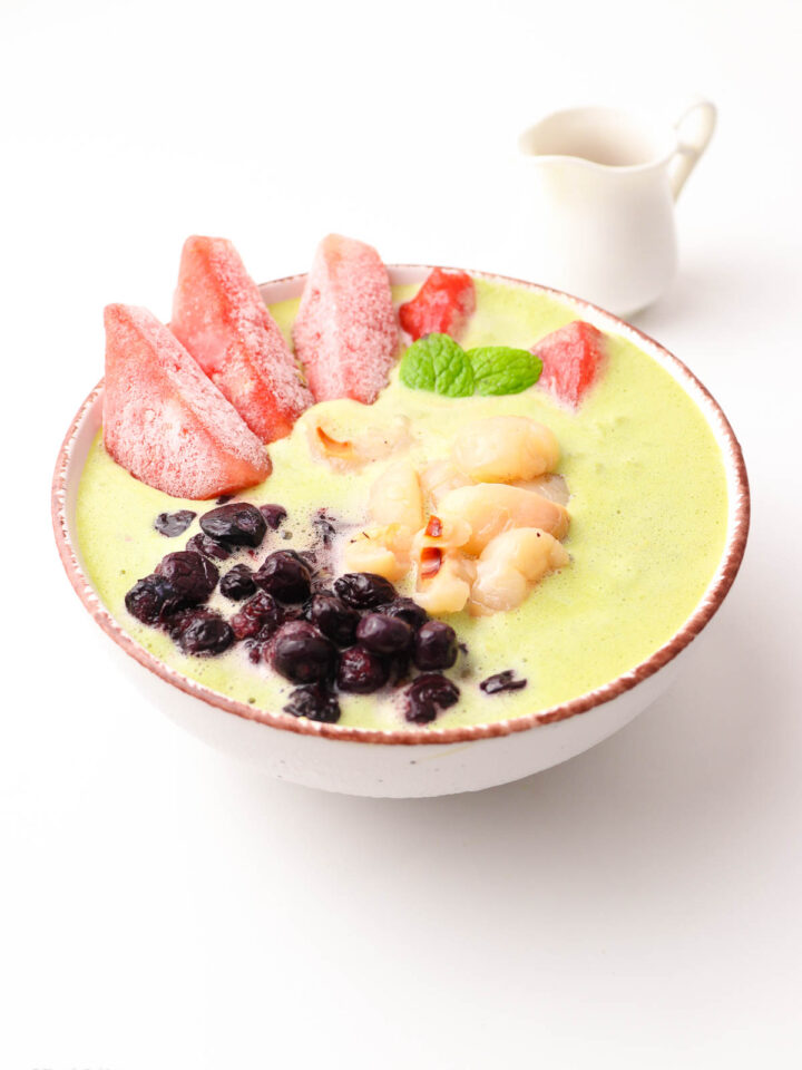 A bowl of delicious Lychee Smoothie next to a cup