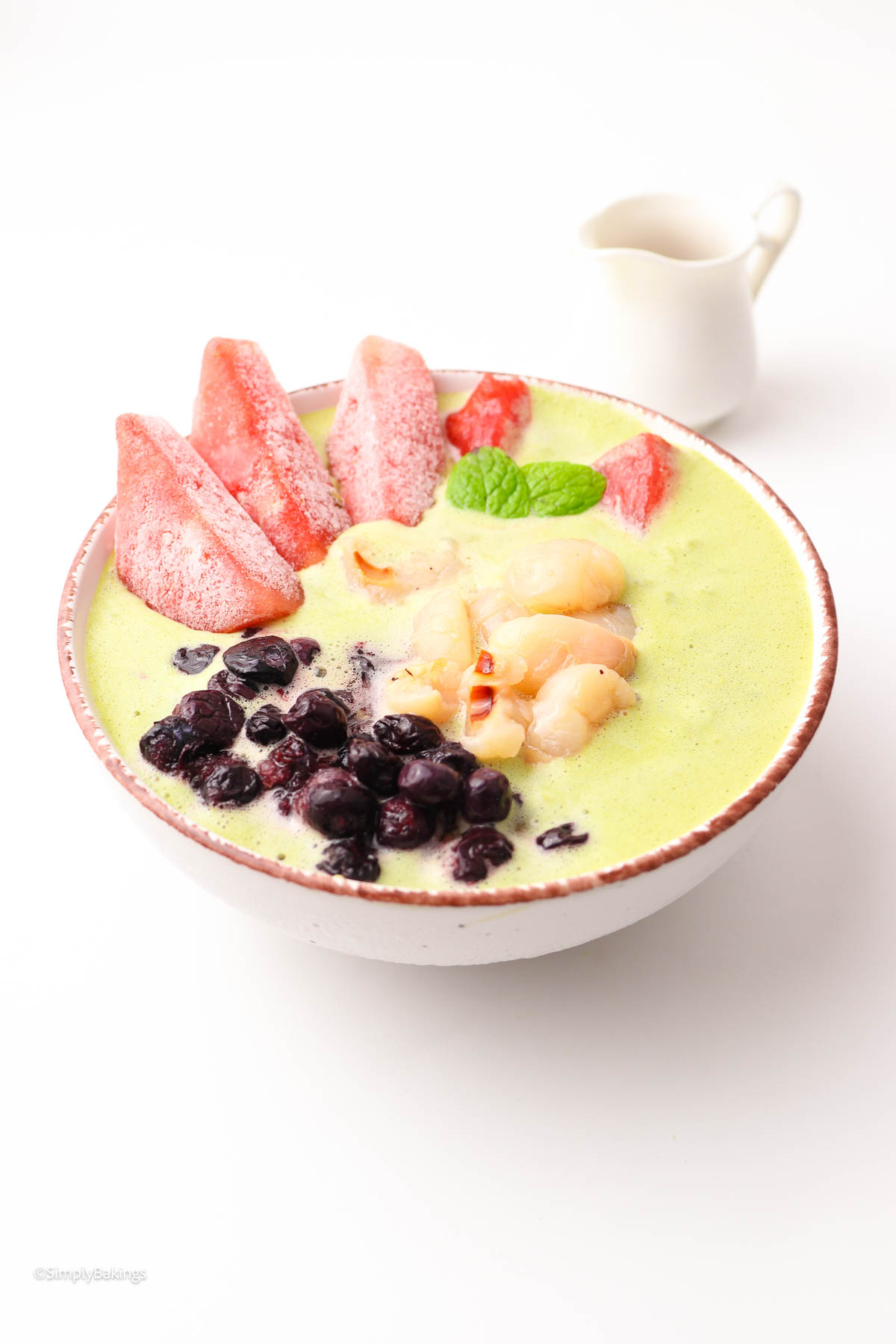 A bowl of delicious Lychee Smoothie next to a cup