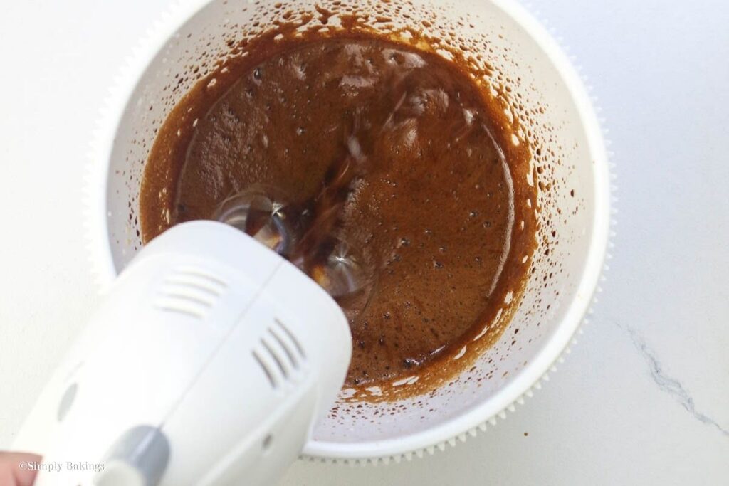 Coffee mixture in a white bowl with a blender