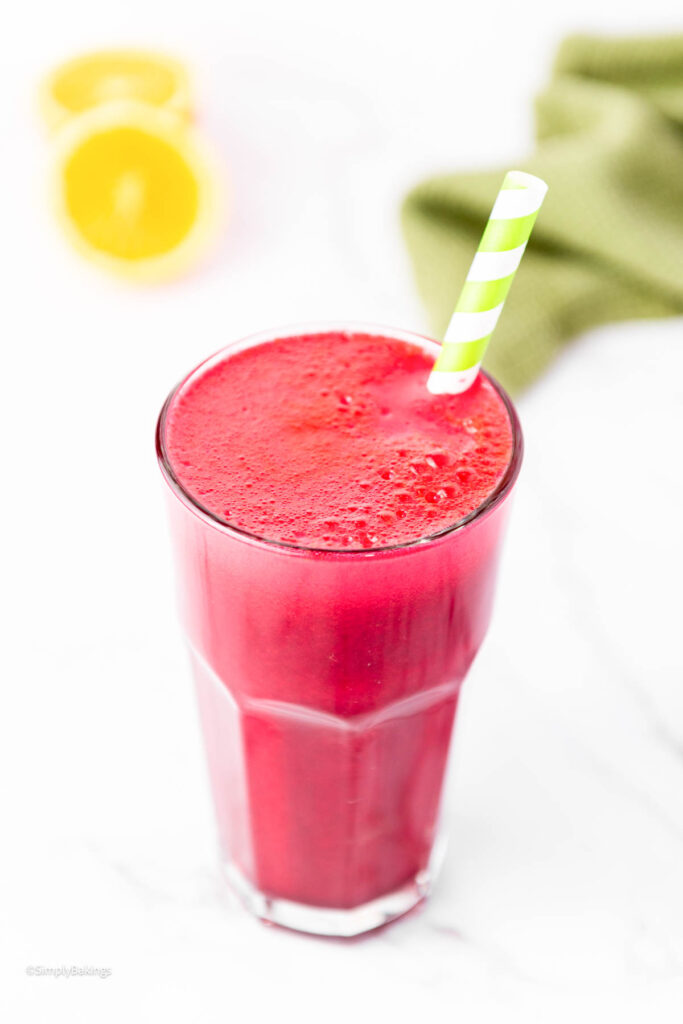 Nutritious red juice in a glass with straw