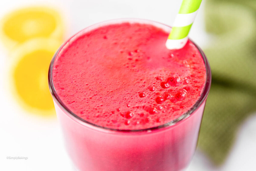 Straw in a tall glass of red juice