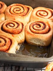 Soft swirly buns side by side in a baking tray