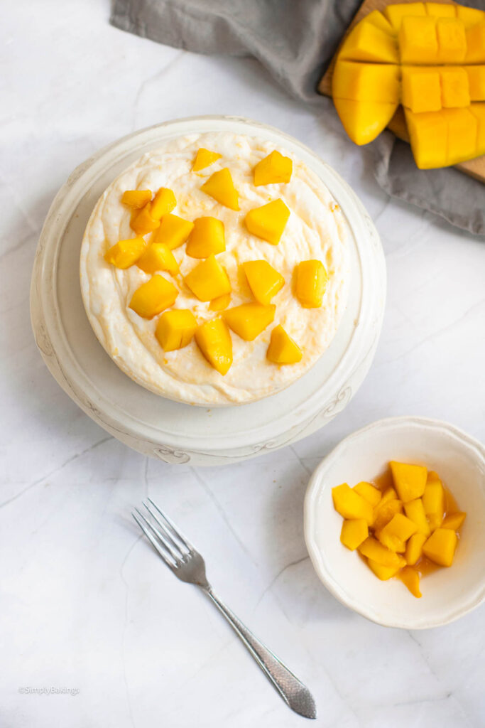 mango cheesecake topped with diced mangoes