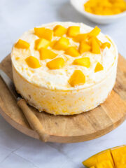 Delicious Mango Cheesecake on a circular wooden board