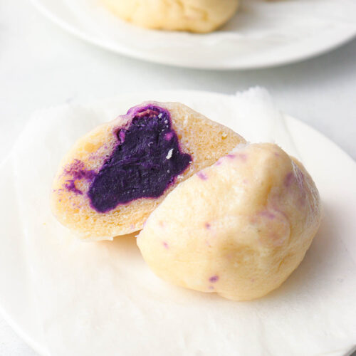 a steamed taro bun sliced in halves with taro paste filling