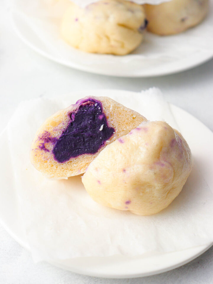 a steamed taro bun sliced in halves with taro paste filling