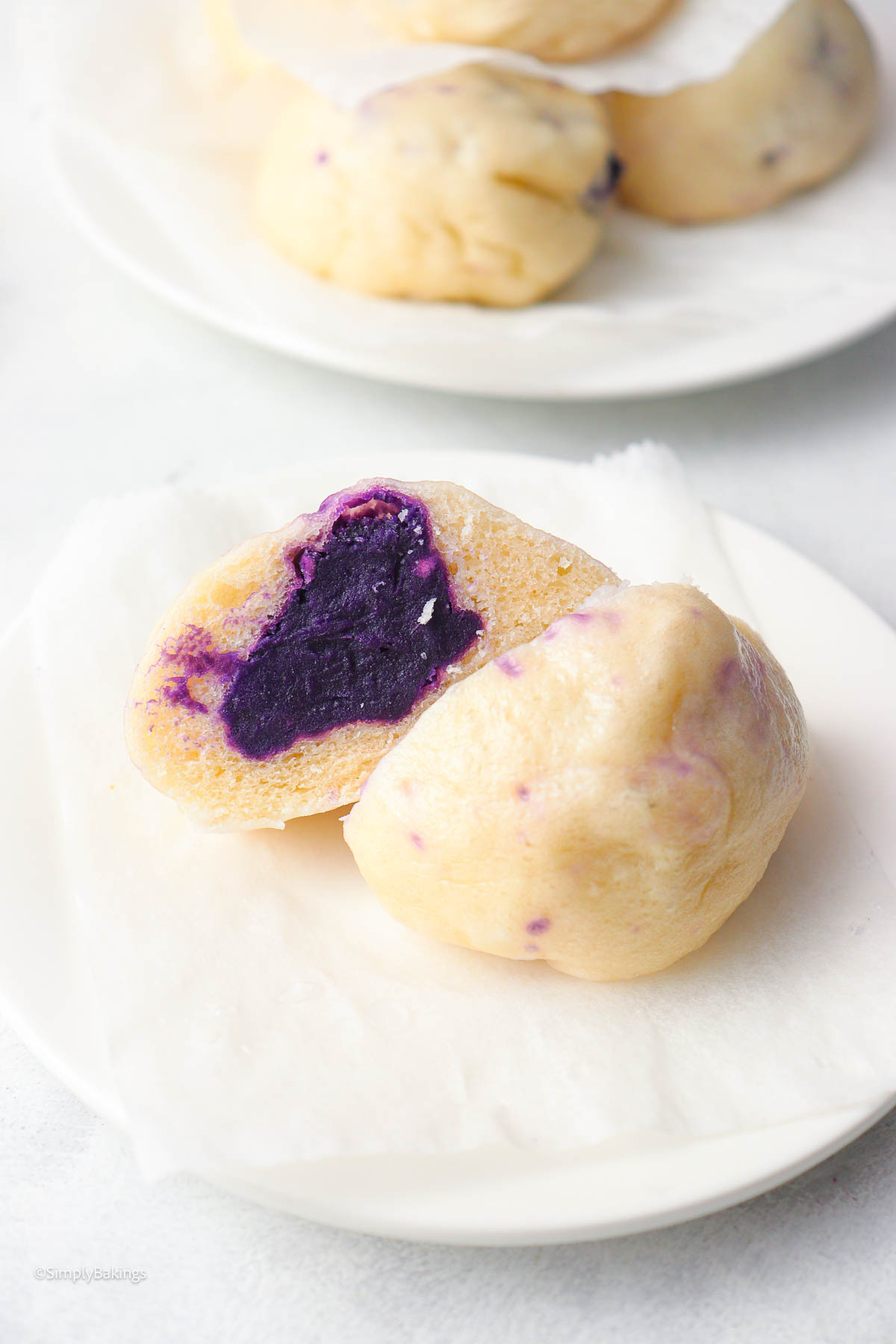 a steamed taro bun sliced in halves with taro paste filling