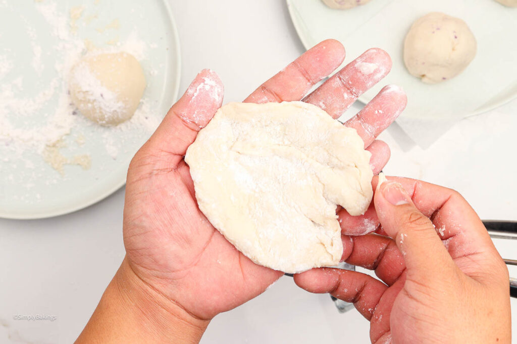 Hands forming the taro bun dough 