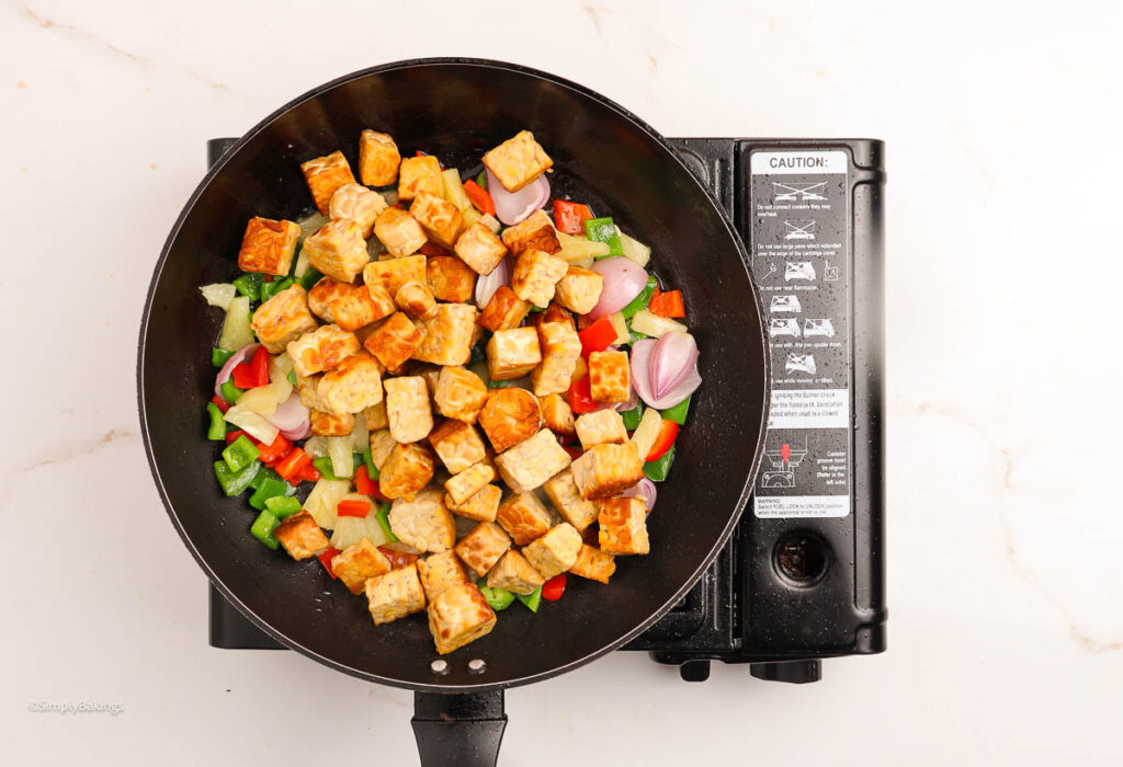 Cubed tempeh with vegetables in pan