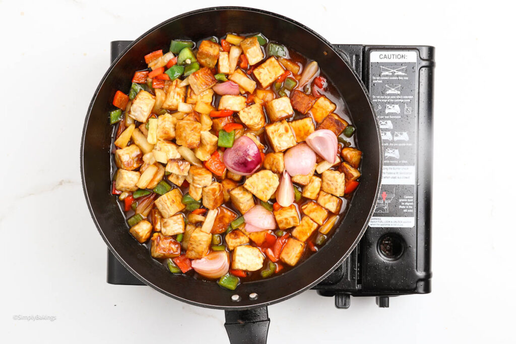 sweet and sour tempeh simmered in a pan