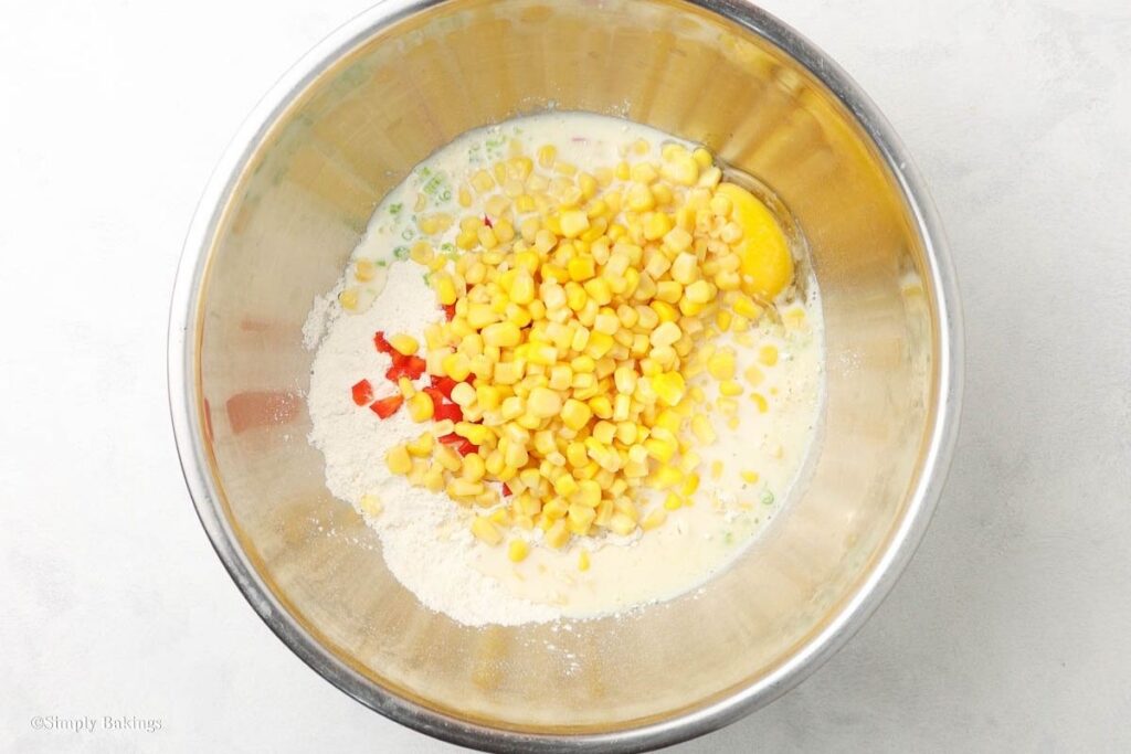 pancake mix, beaten egg, buttermilk, red bell pepper, corn kernels, and spring onions combined in a medium bowl