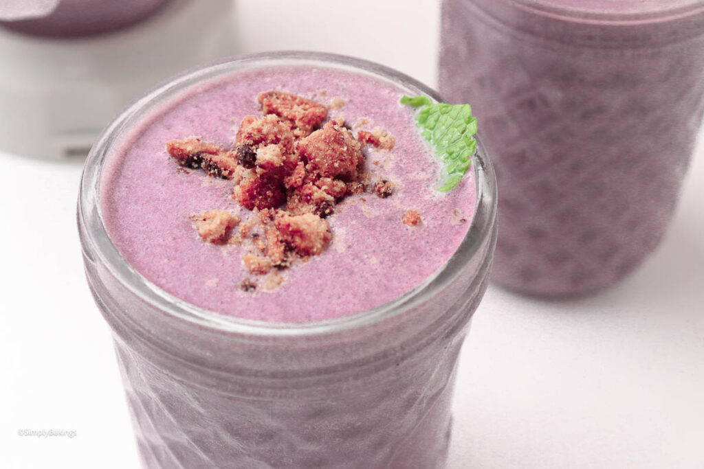 Mint leaves and cookie crumble on Ube milkshake