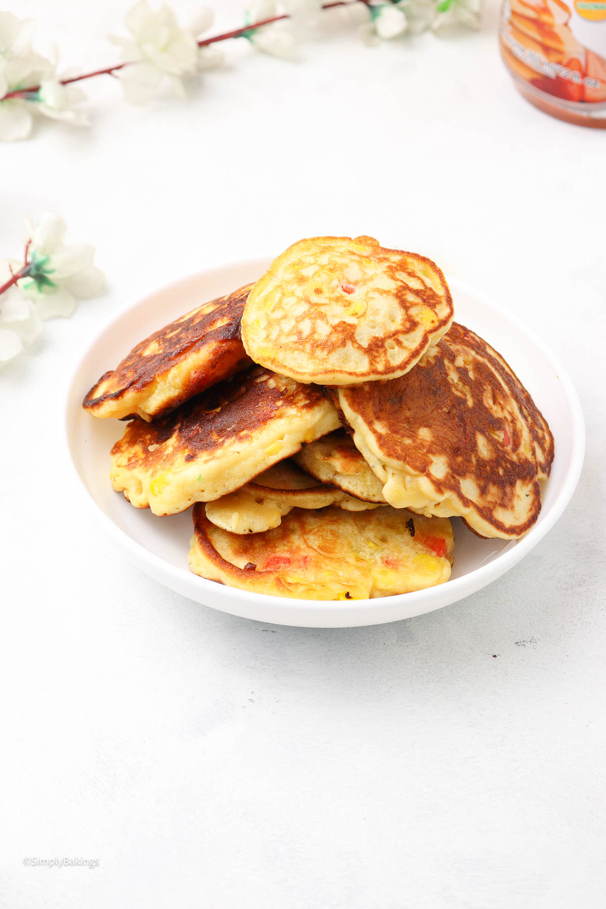 stacks of Corn Fritters with Pancake mix in a white bowl