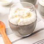 Black Sesame Pudding in a glass topped with whipped cream