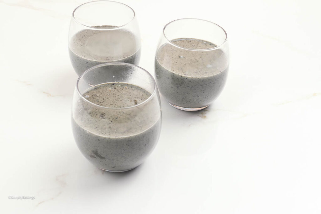 black sesame pudding mixture poured into three cups