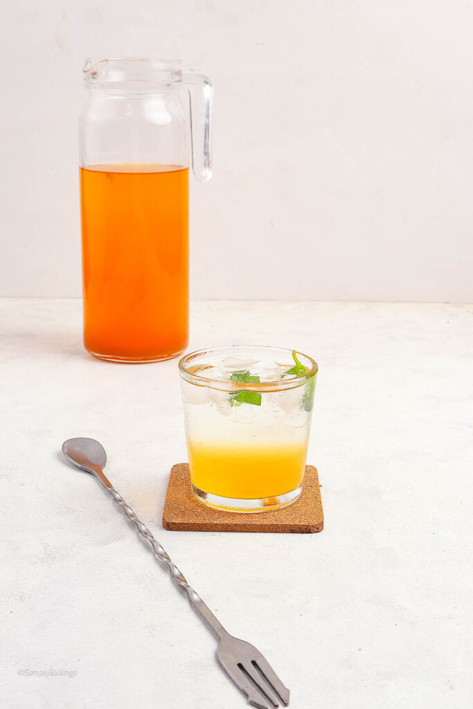 Glass of Tamarind Drink next to a pitcher