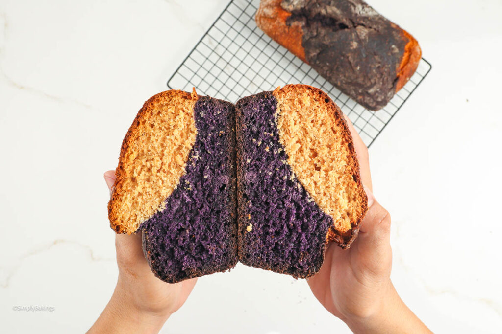 Hands holding a sliced loaf of Coconut Ube Milk Bread