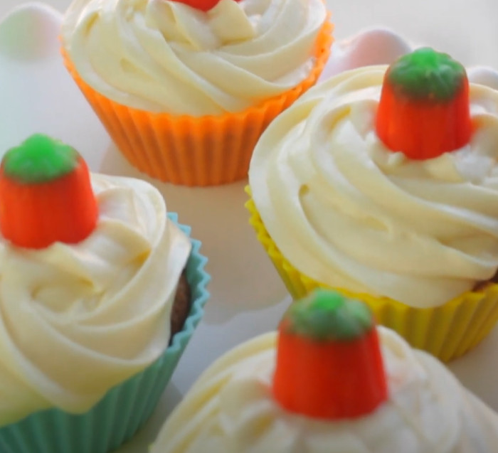 pumpkin cupcakes with white frosting