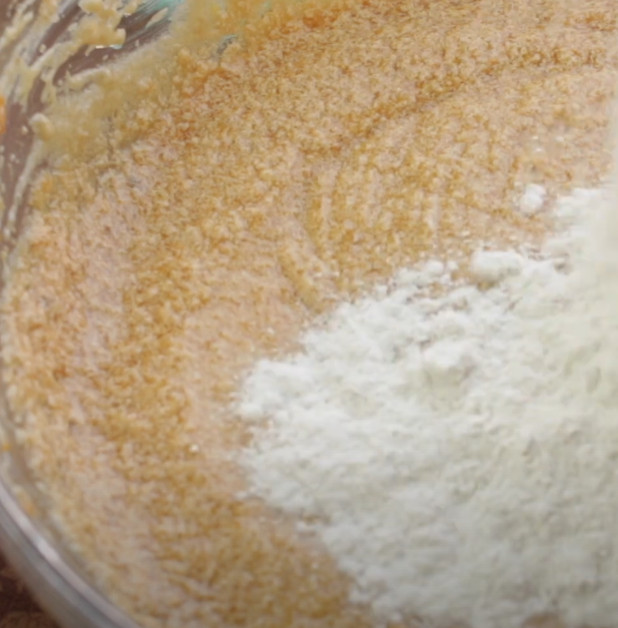 adding flour to batter