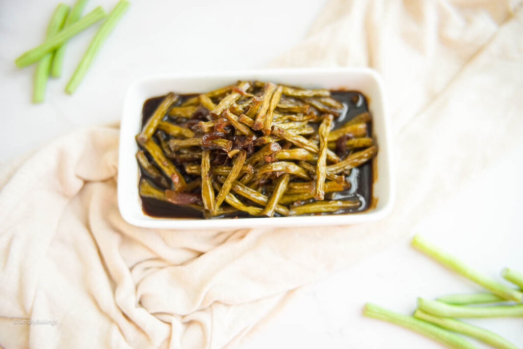 Adobong Sitaw Without Meat served at the table with a cloth and string bean slices
