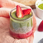 Strawberry Matcha Pudding in a cute glass cup with sliced strawberry topping