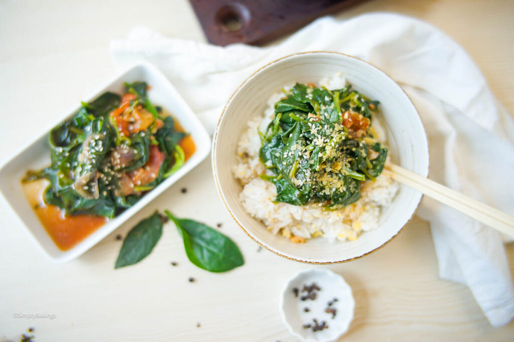 A bowl of fresh Alugbati dish on top of rice