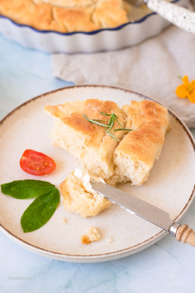 Focaccia decorated with tomatoes and onions
