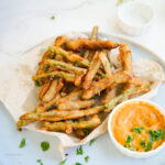 A bowl of deep-fried string beans with sauce