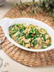 freshly cooked pechay with scrambled eggs served in a white bowl