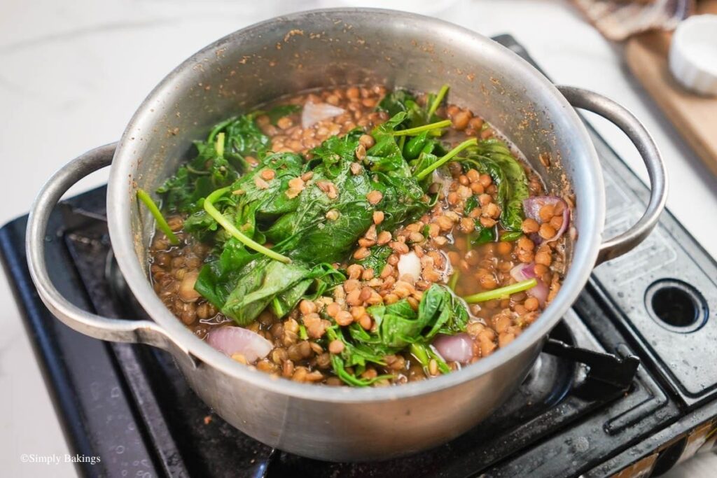 A boiling pot of lentil soup on the stove
