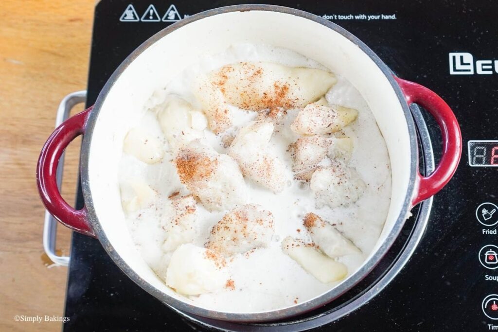 A hot pot filled of taro and coconut milk over heat