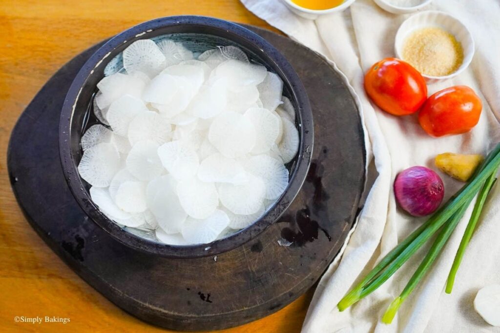 Wooden bowl filled with slices of radish