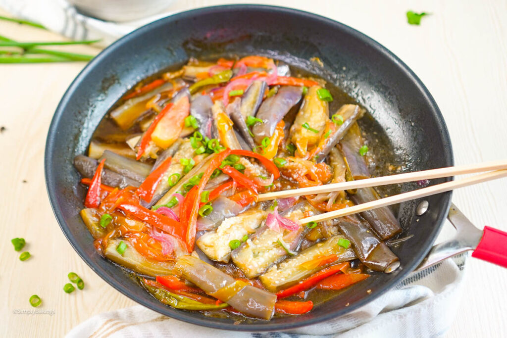 Talong Paksiw in a frying pan with chopsticks