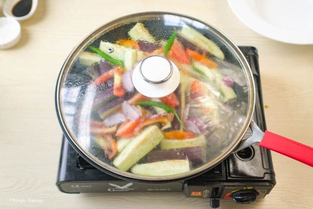 Veggies and spices cooking in a pan