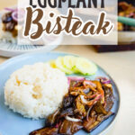 eggplant bisteak served with steamed rice on a plate