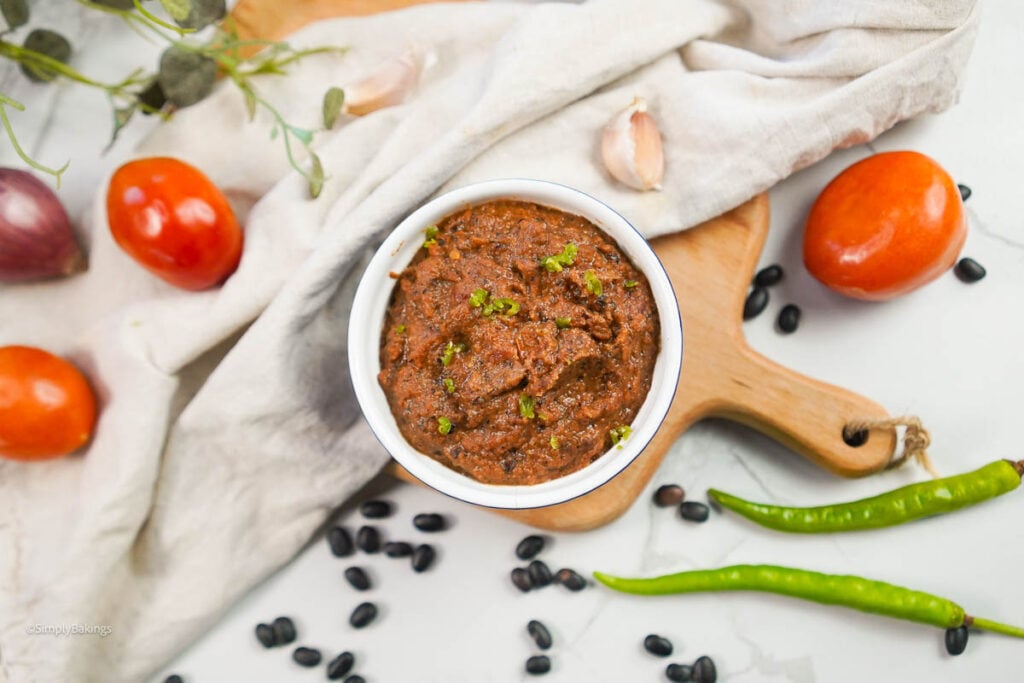 Kamatis bagoong surrounded by ingredients