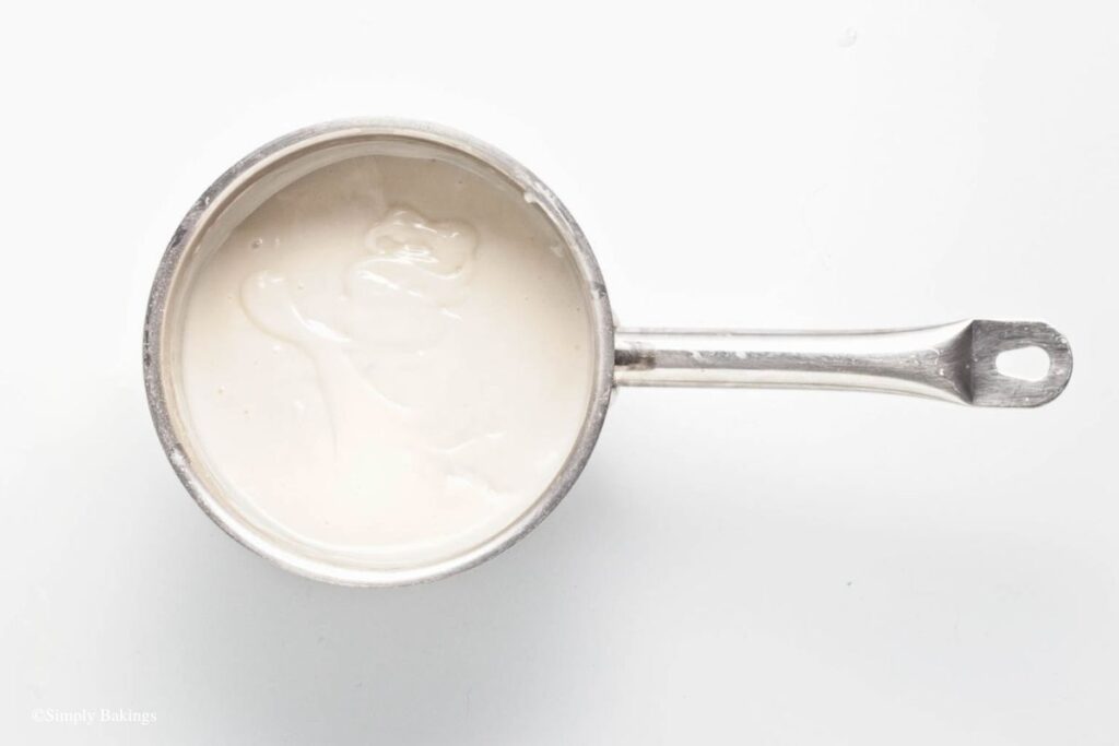 Mango pudding mixture in a silver pan