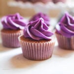Ube cupcakes side by side at the table