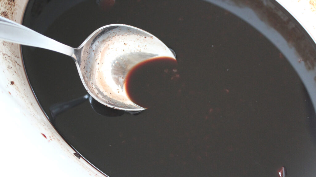 elderberry juice in a while bowl and a spoon 