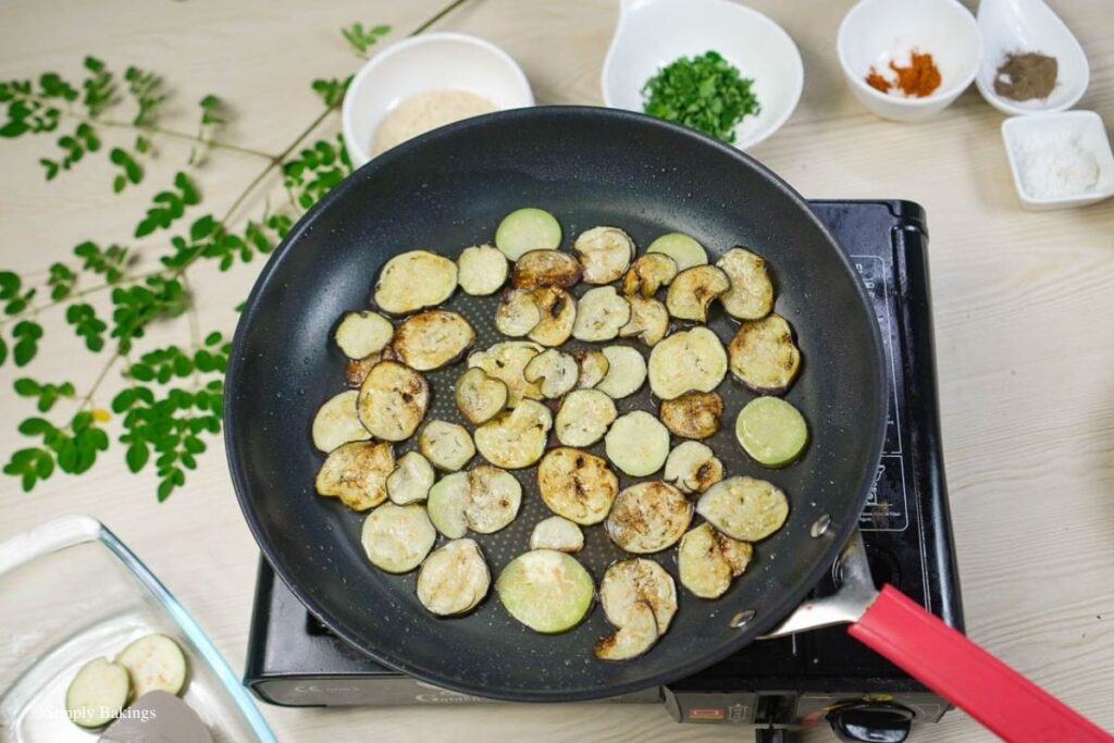 frying eggplant slices in a pan