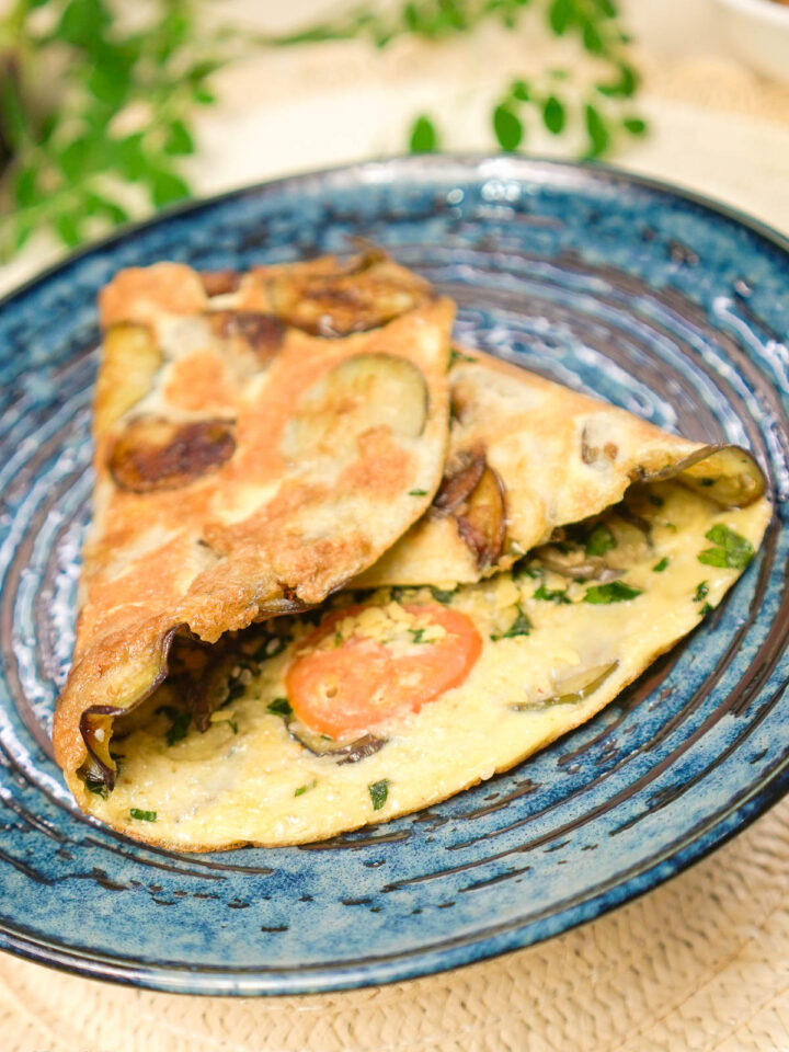 Eggplant omelette served on a blue plate
